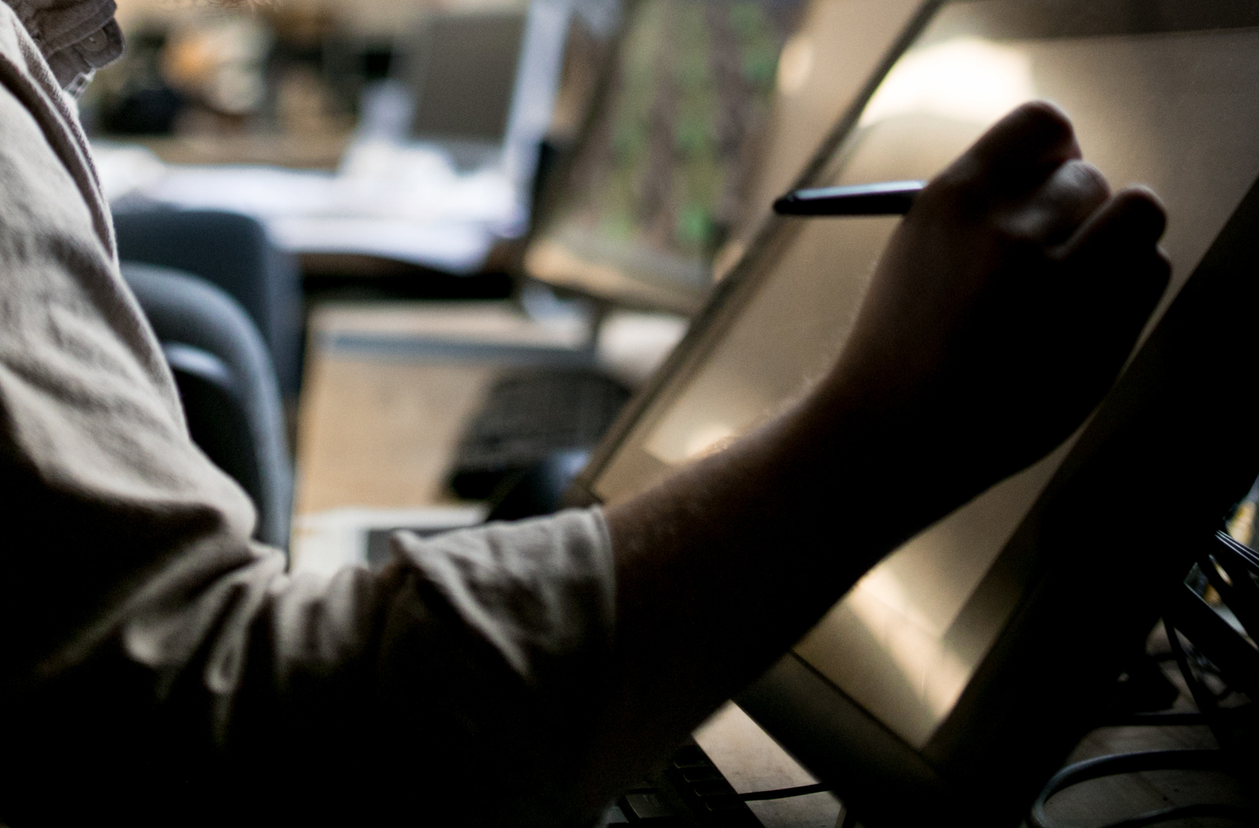 color photograph showing detail of hand drawing on Cintiq tablet.