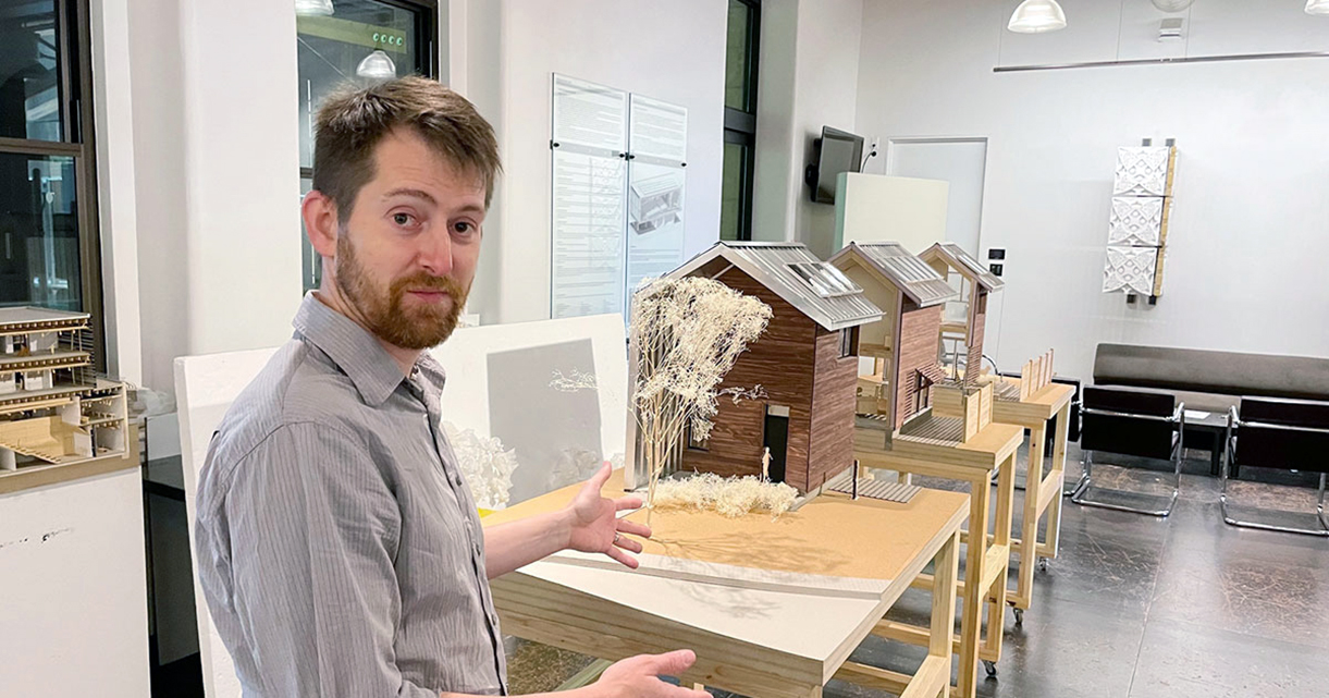 Chad Kraus with a model of the home Dirt Works Studio will build in Kansas City, Kansas, as part of the 2023 Solar Decathlon Build Challenge. Credit: Rick Hellman, KU News Service.