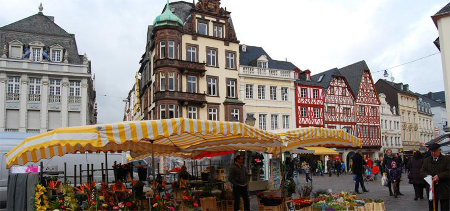 Row of German buildings with a market in front