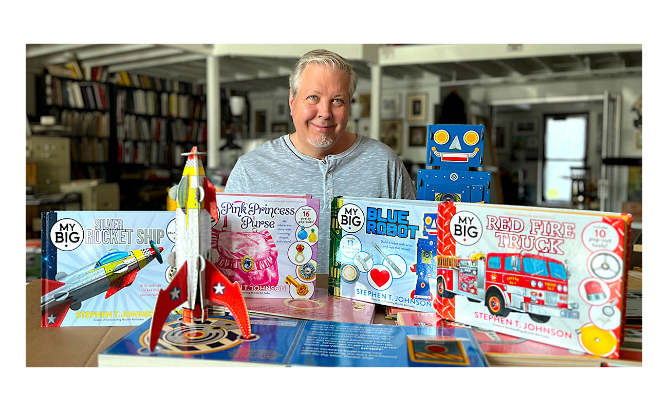 Photo: Stephen T. Johnson in his studio with his newly published series of children’s books.