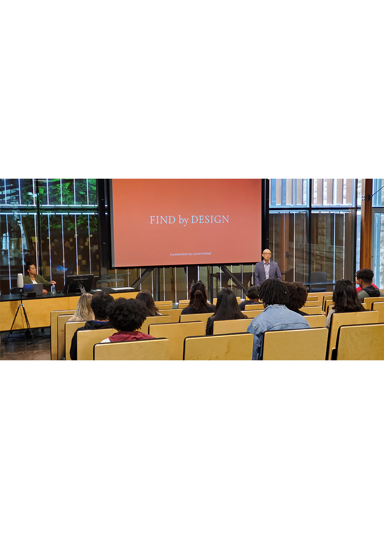 Students sit in Marvin Forum to watch a presentation.